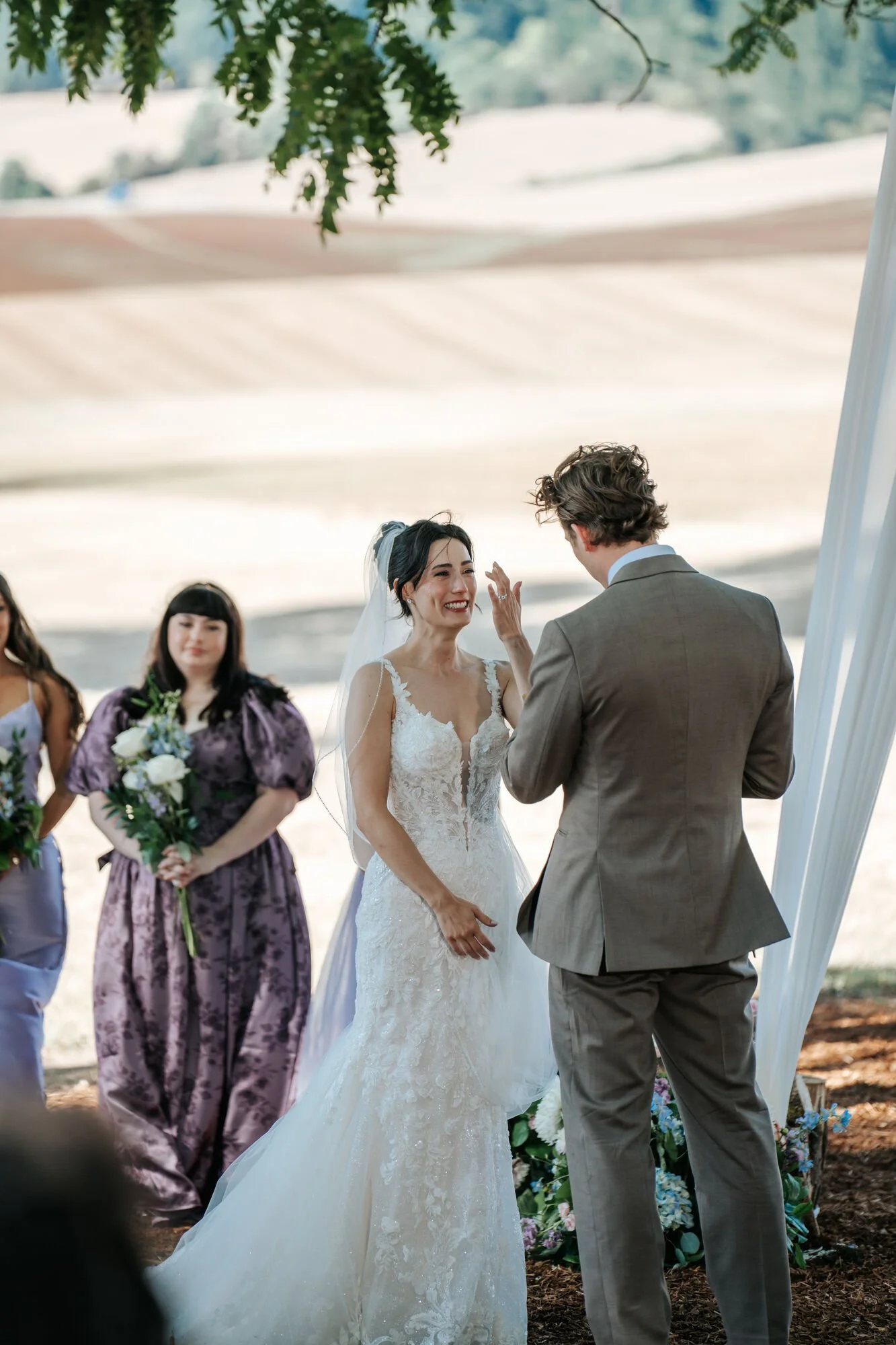 Emotional ceremony moment as bride and groom hold hands in Humboldt County. Heartfelt wedding photography by Tex Kelly, specializing in rustic outdoor weddings in Northern California.