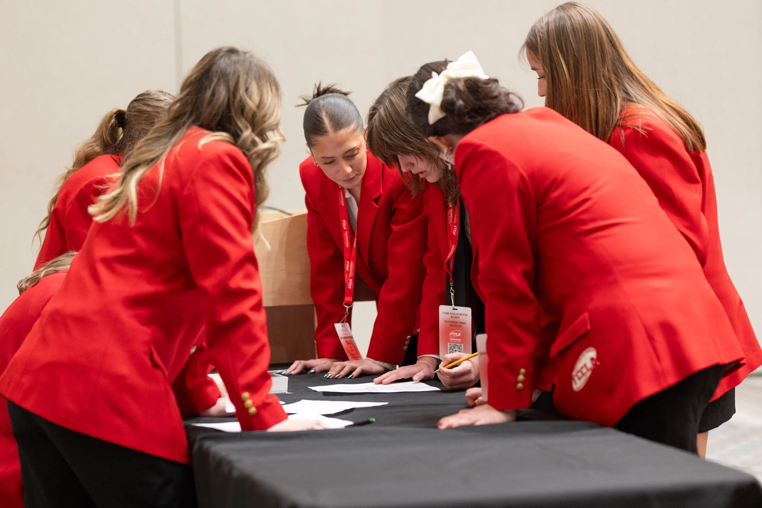 A group of FCCLA student members gather to solve a problem.
