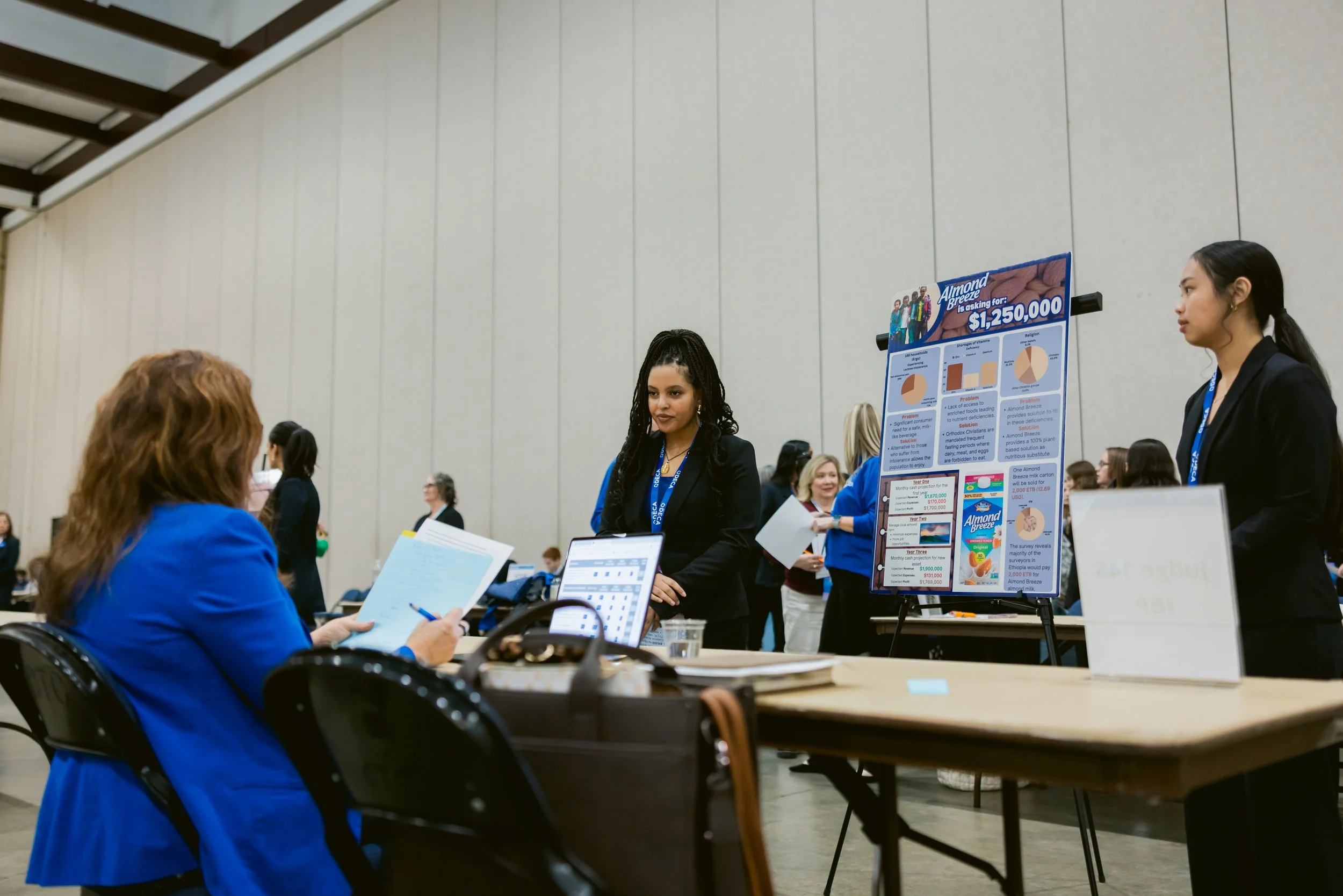 Two students present in their competition in front of a volunteer judge.