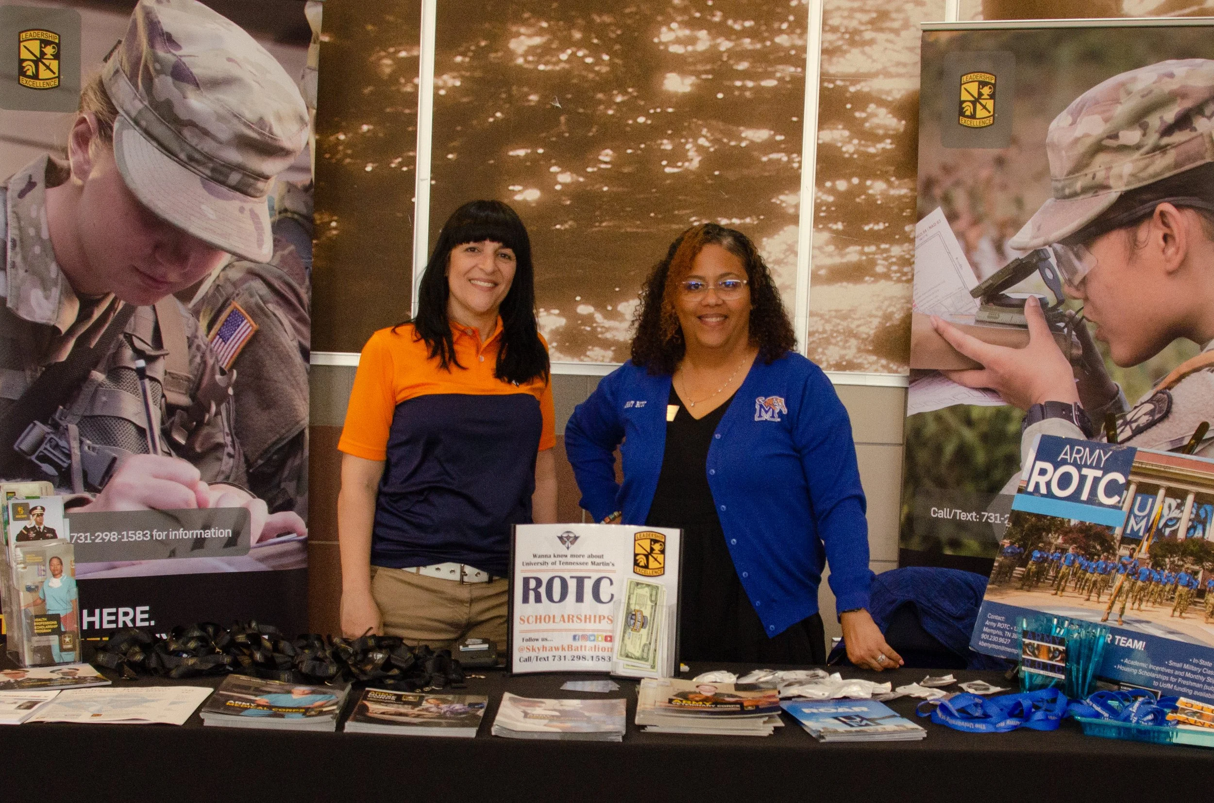 Exhibitors for the State Leadership Conference pose for a photo at an exhibit booth.