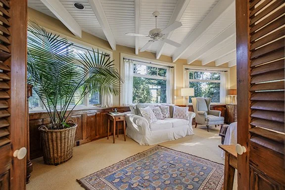 Shutter doors opening into sitting room of El Salto estate in Arroyo Seco, New Mexico
