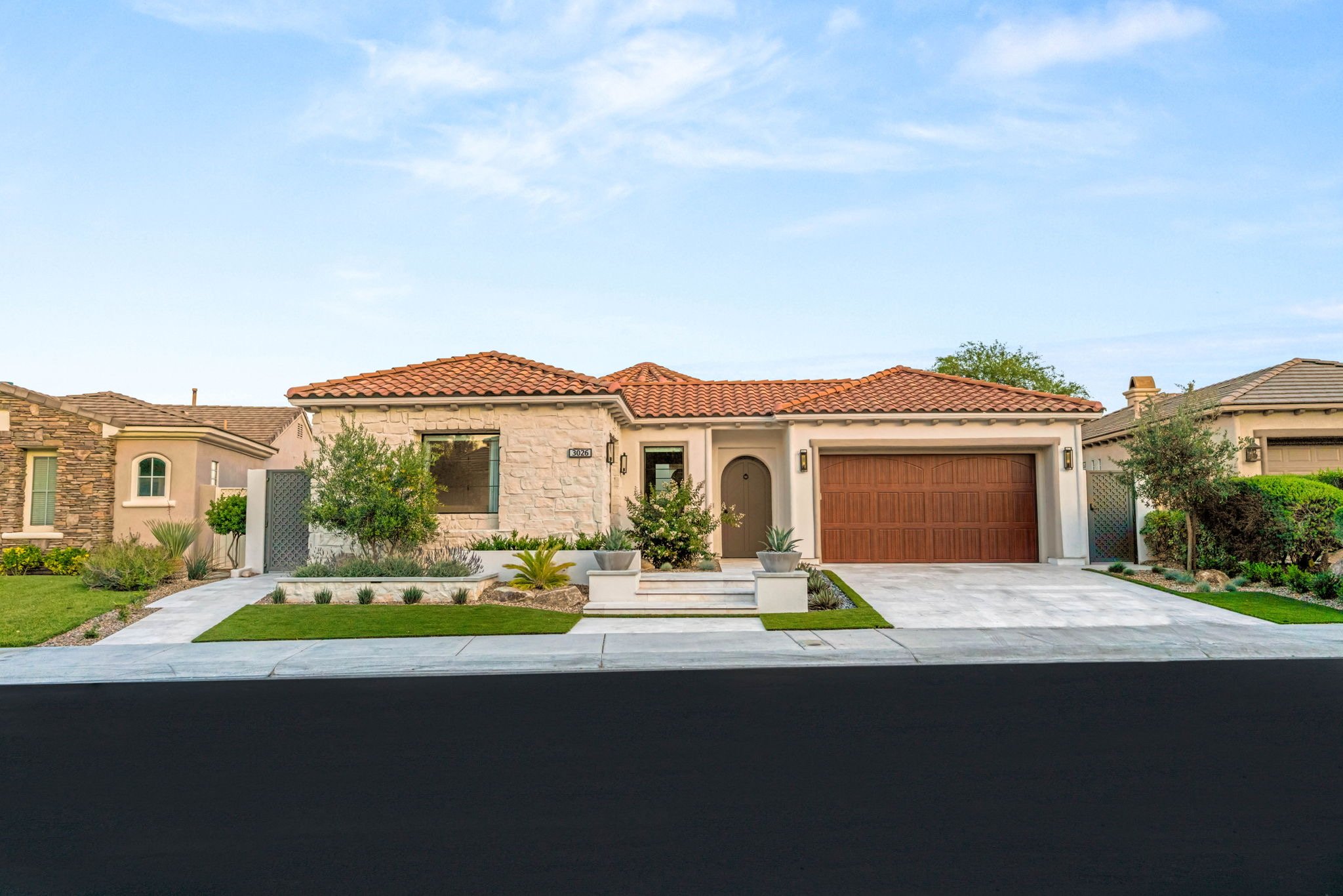 Custom residential front yard landscape installation with stone paver entryway and low-maintenance desert landscaping on Soft Horizon Way, Las Vegas.