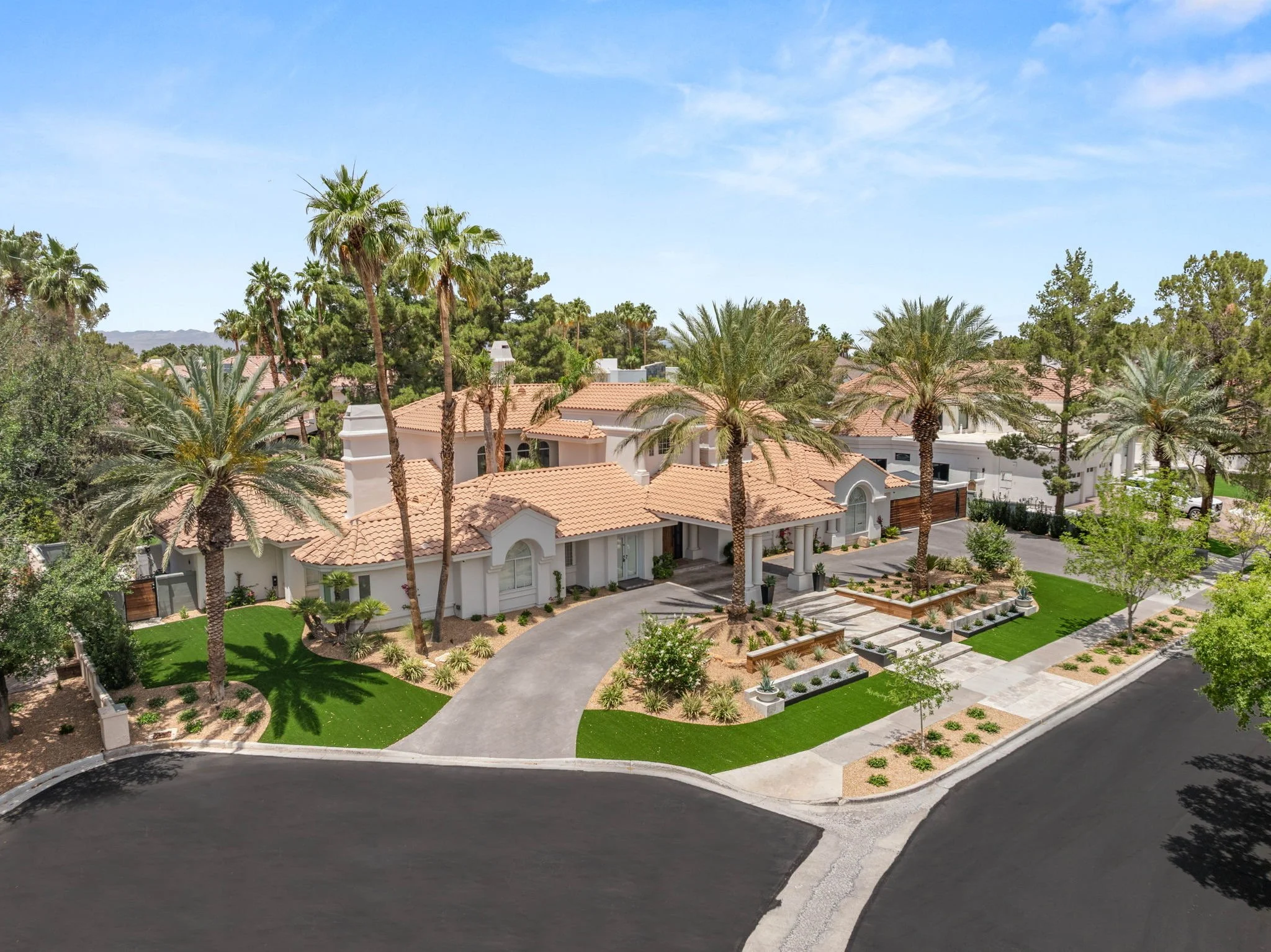 Luxury residential front entrance landscape installation with custom paver driveway and desert palm landscaping in Las Vegas.