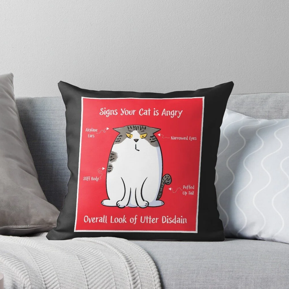 diagram of an angry brown and white tabby cat with a red background on a black throw pillow