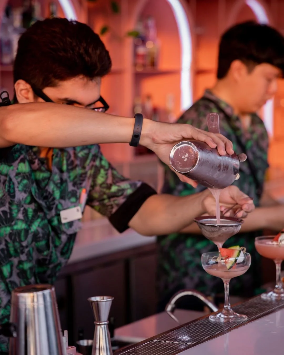 The evening glow hits different up here. It's golden hour on the rooftop, and the real magic happens behind the bar. Watch the expert pour, a smooth stream of something good, just as the city lights begin to flicker on.

This is the hour when the moo