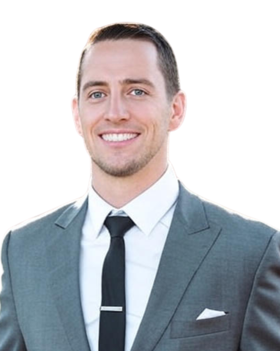 A smiling man in a gray suit, white shirt, and black tie, with a white pocket square, against a plain white background.