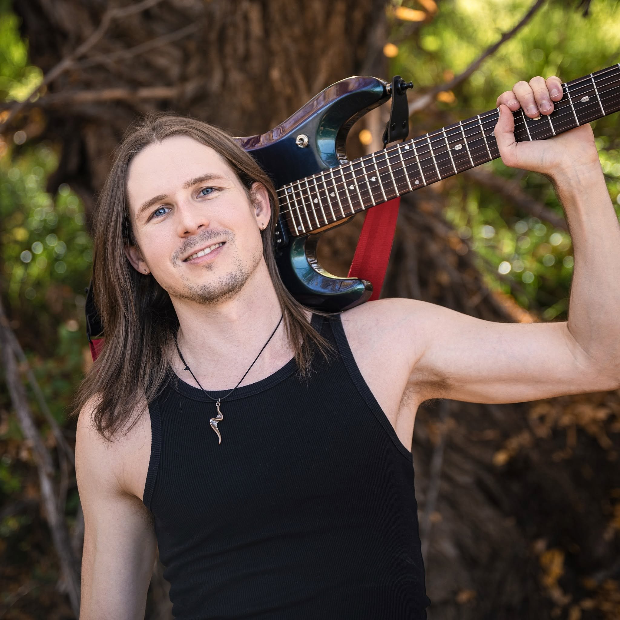 Matt Wright posing with Music Man JP7 guitar