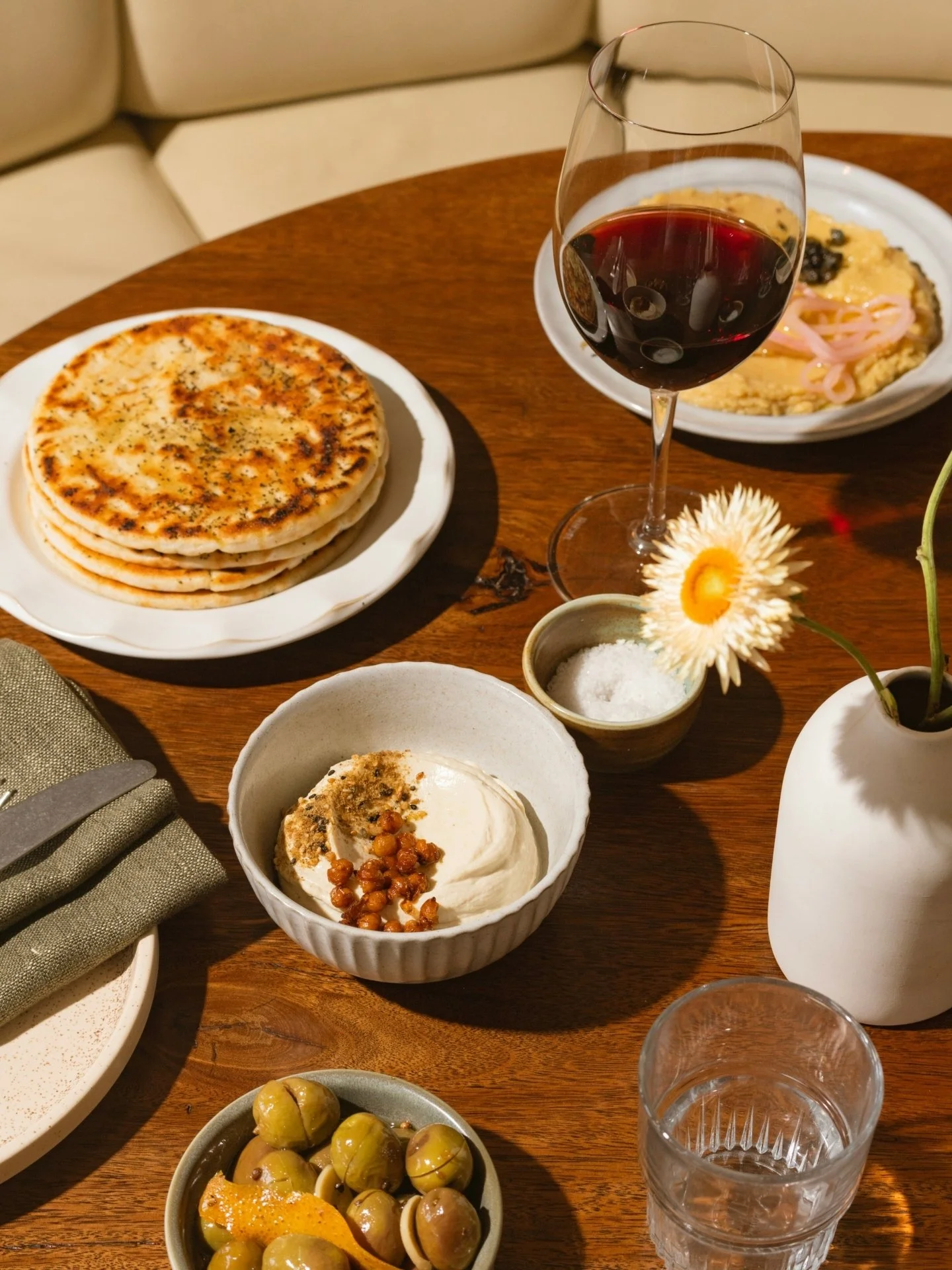 Lunch begins like this. A table of small plates and a glass of something good.