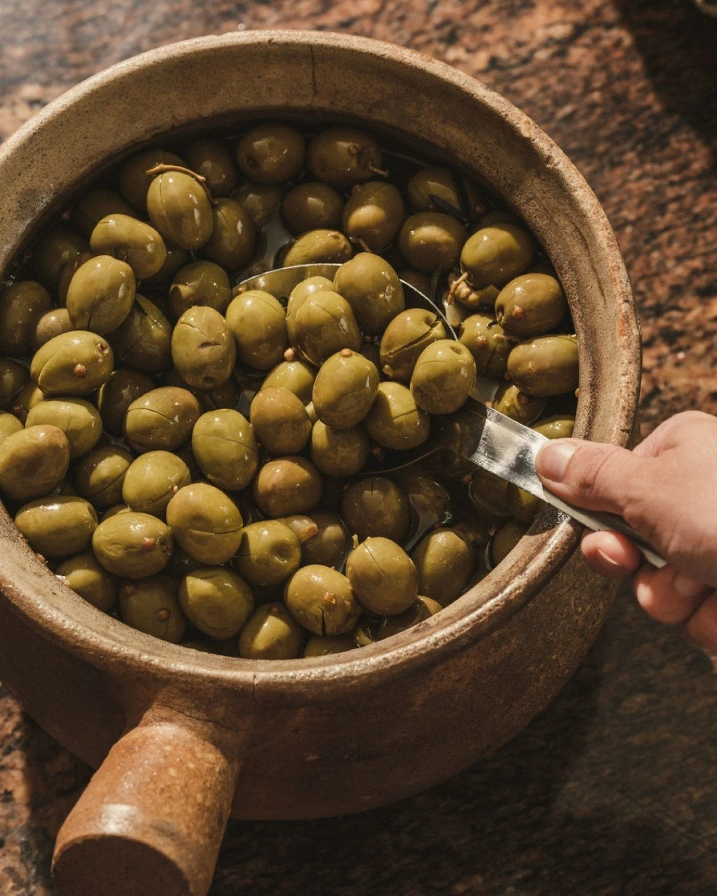 Every table starts the same way. Olives, olive oil, and the ritual begins.