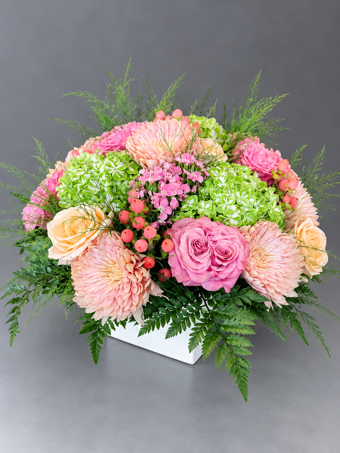 Pastel Pink Floral Arrangement in White Vase.png
