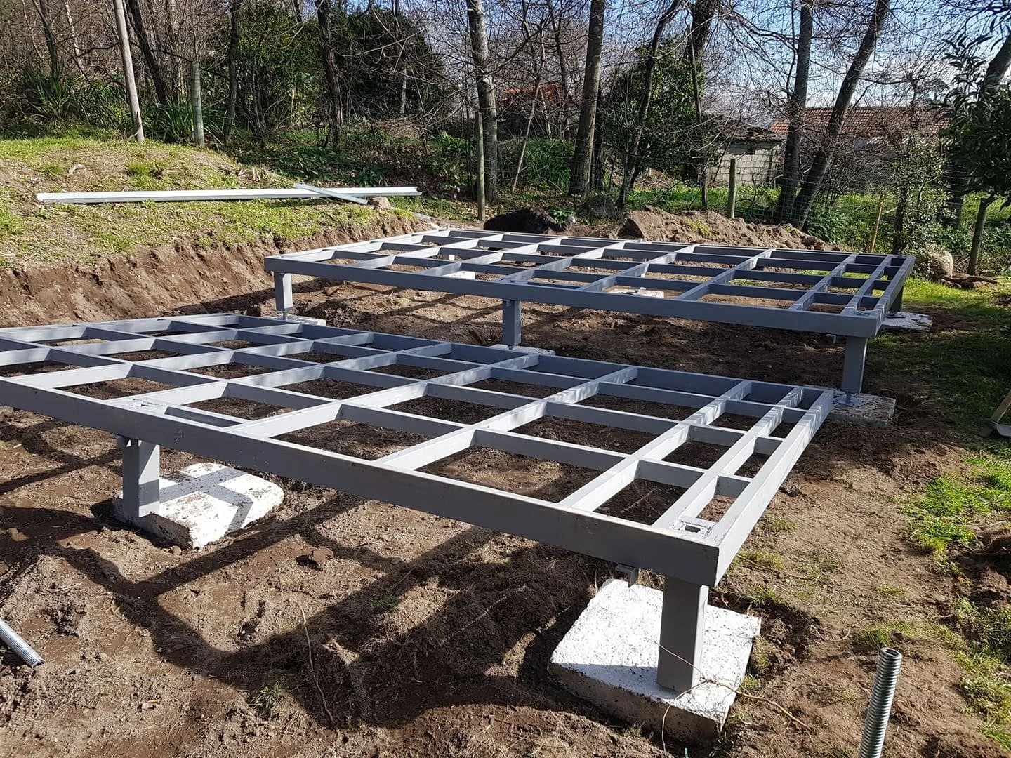Minimalist modern interior with large window, staircase, mirror, and red cloth on bench.