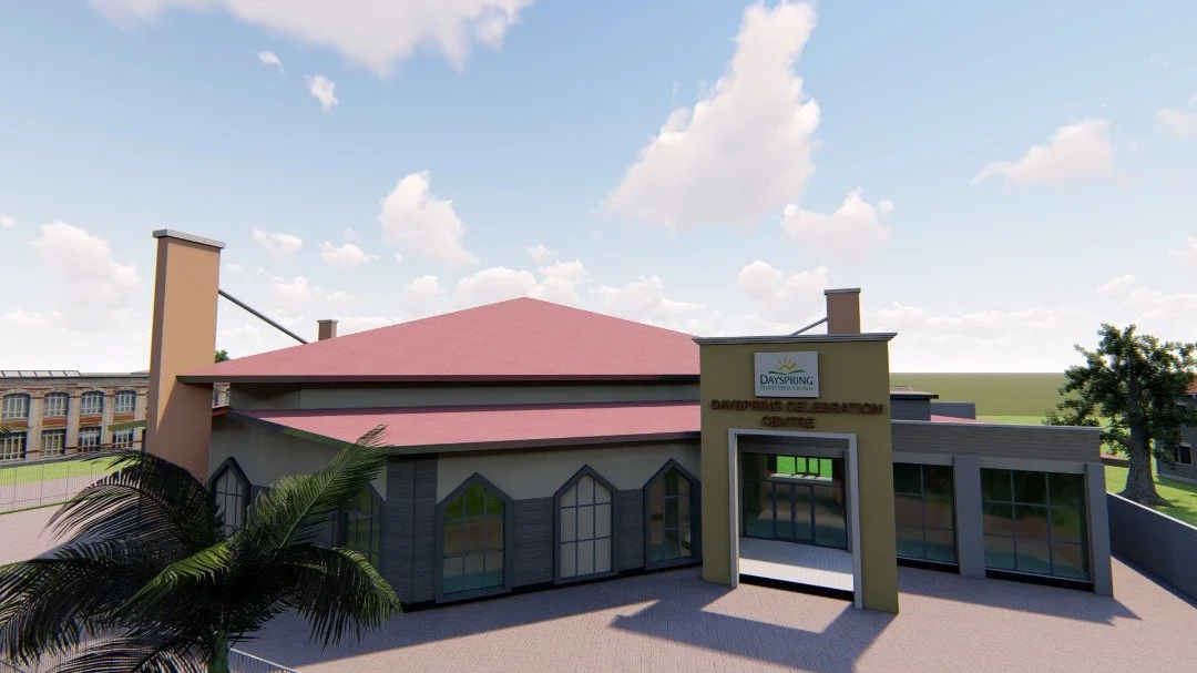 A modern building with a pink roof, labeled 'Dayspring Celebration Centre', featuring large glass windows and surrounded by a paved area and some trees, with a partly cloudy sky overhead.