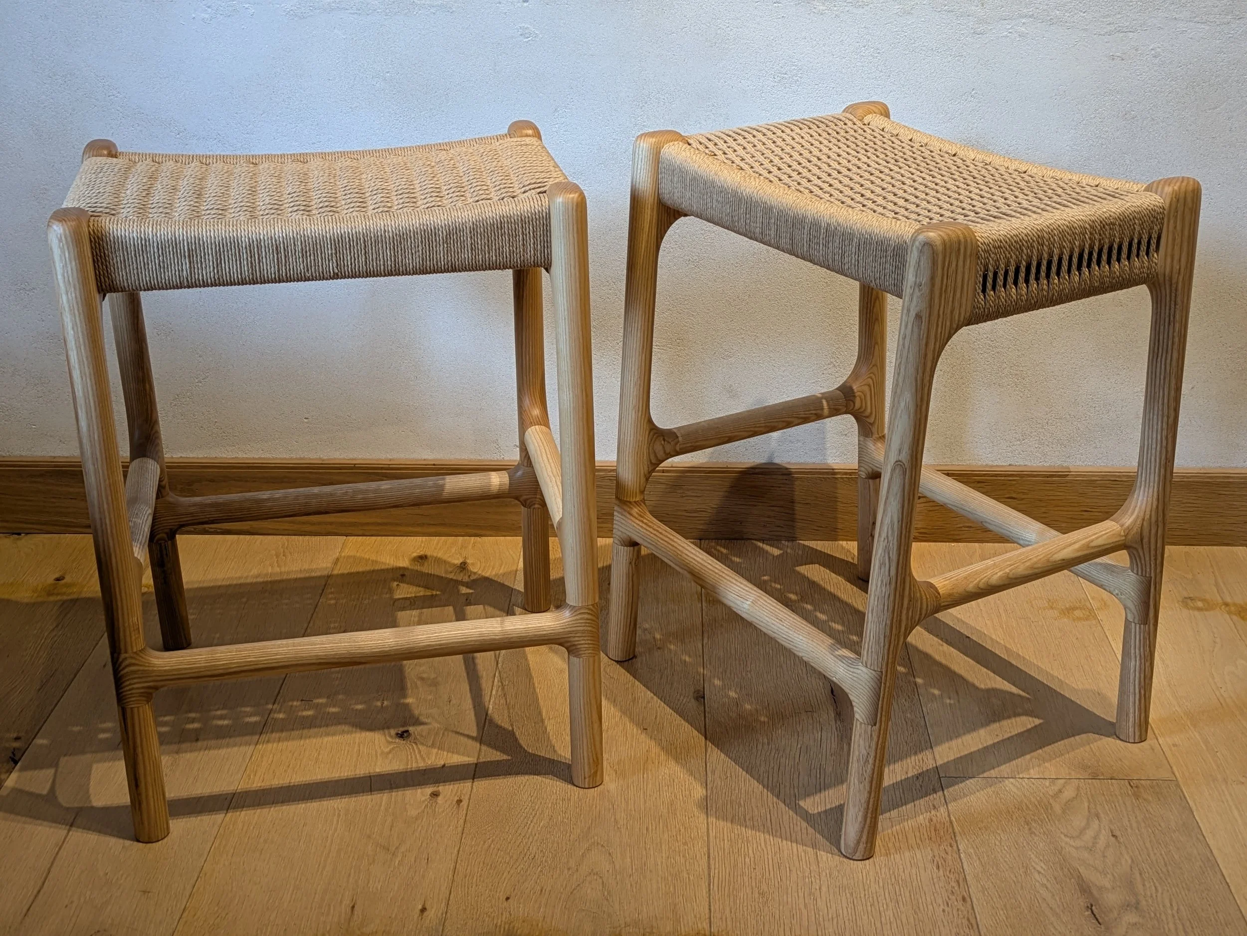 Two Rast counter stools side by side, showing reversible footrest design front and back