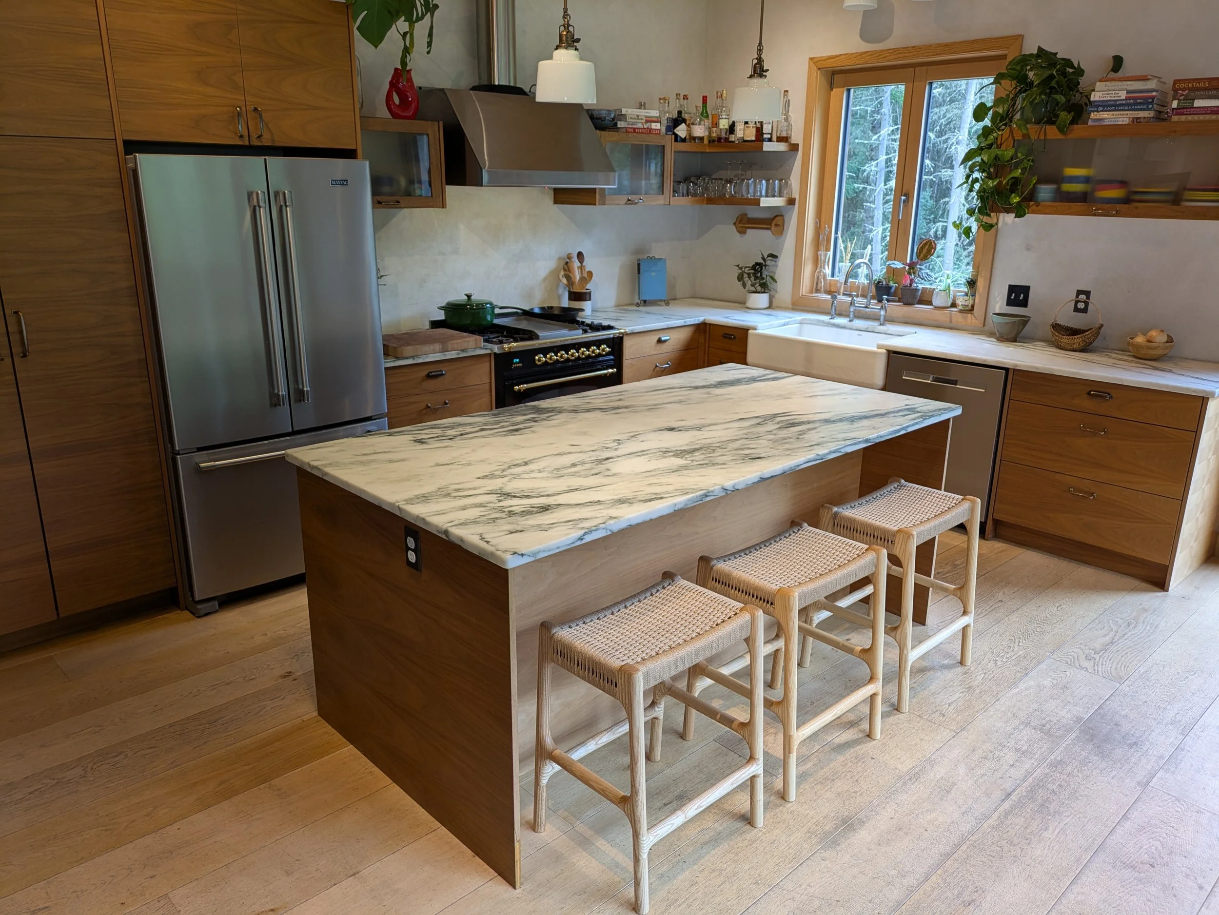 Set of Rast counter stools at marble-topped kitchen island, Pacific Northwest craftsman kitchen