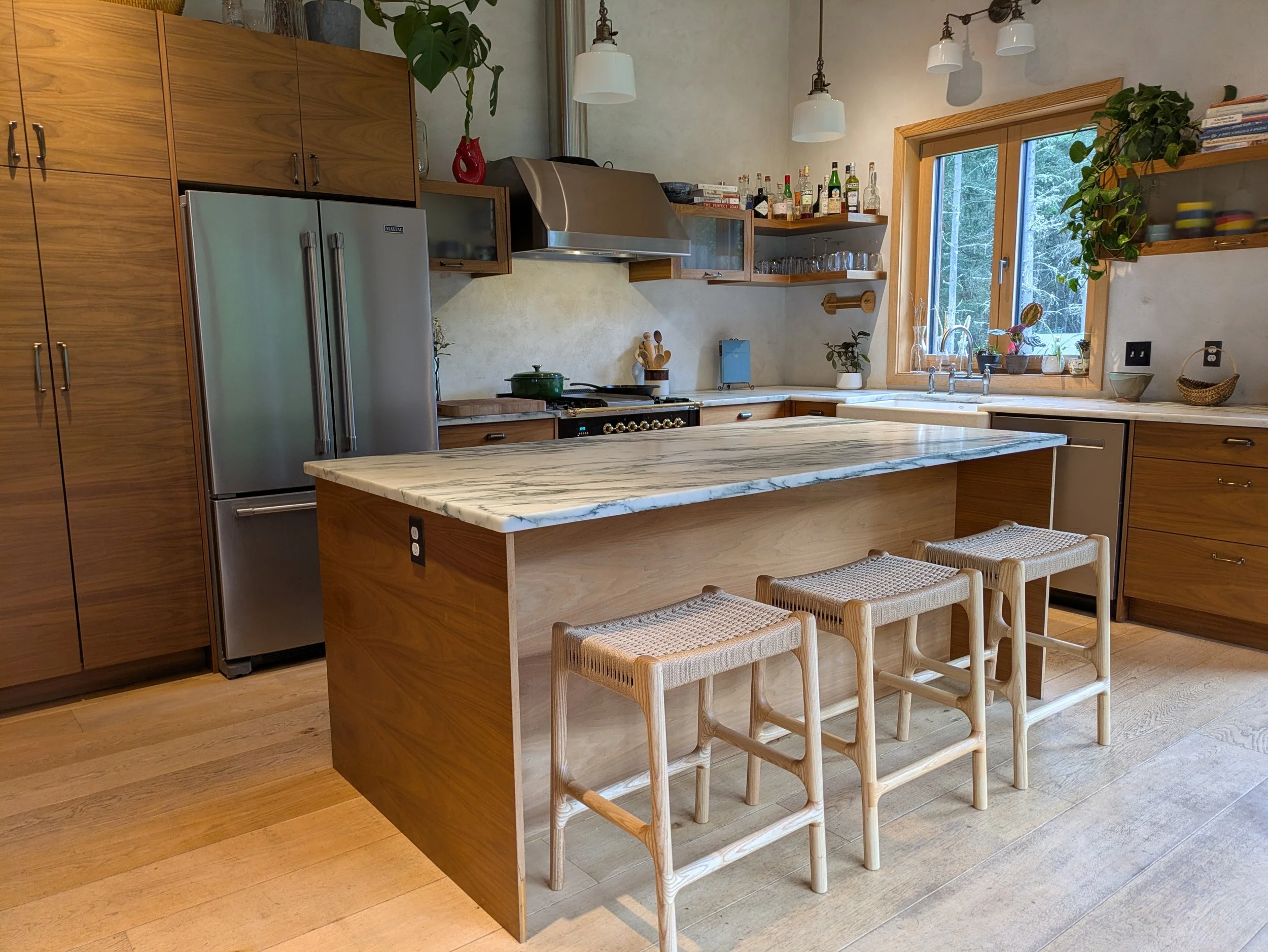 Rast counter stools at kitchen island with marble countertop, Pacific Northwest kitchen