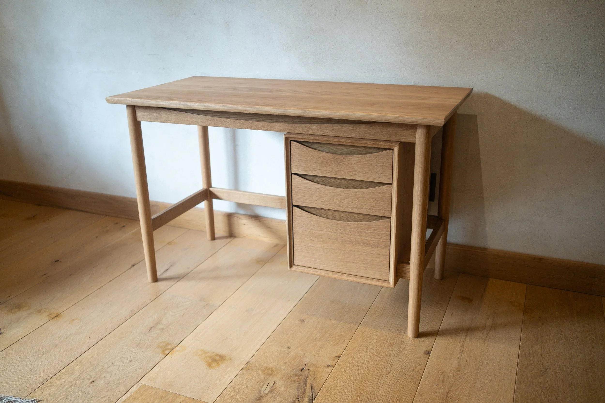 Wren Desk full view, front angle, solid white oak with floating drawer bank