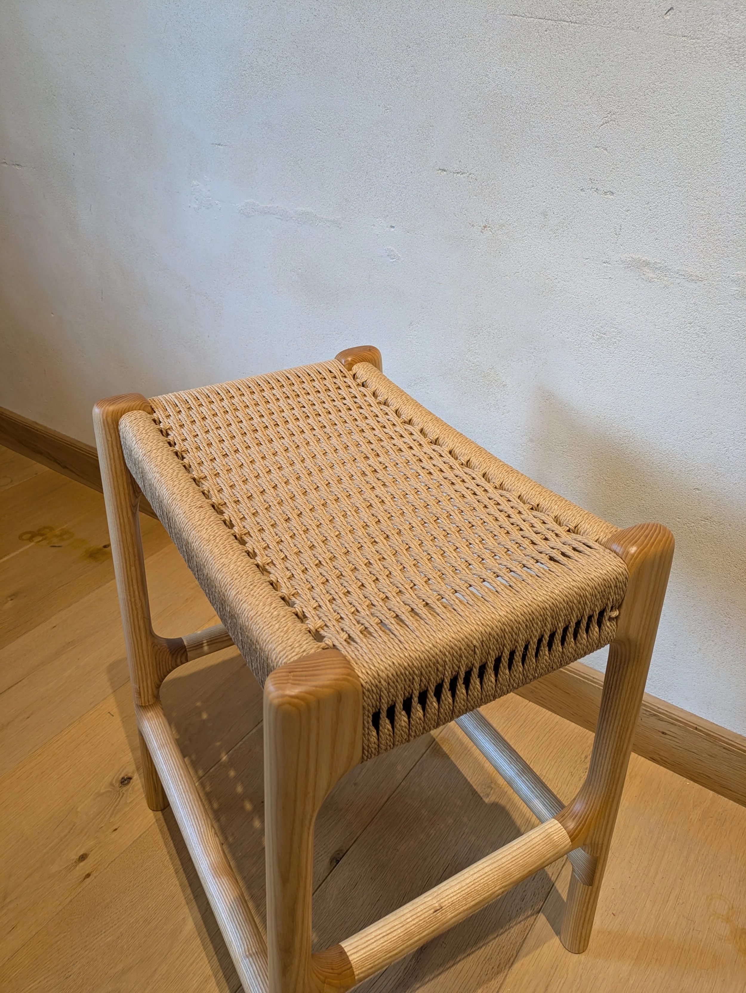 Hand-woven Danish cord seat on Rast counter stool, corner detail showing cord weave