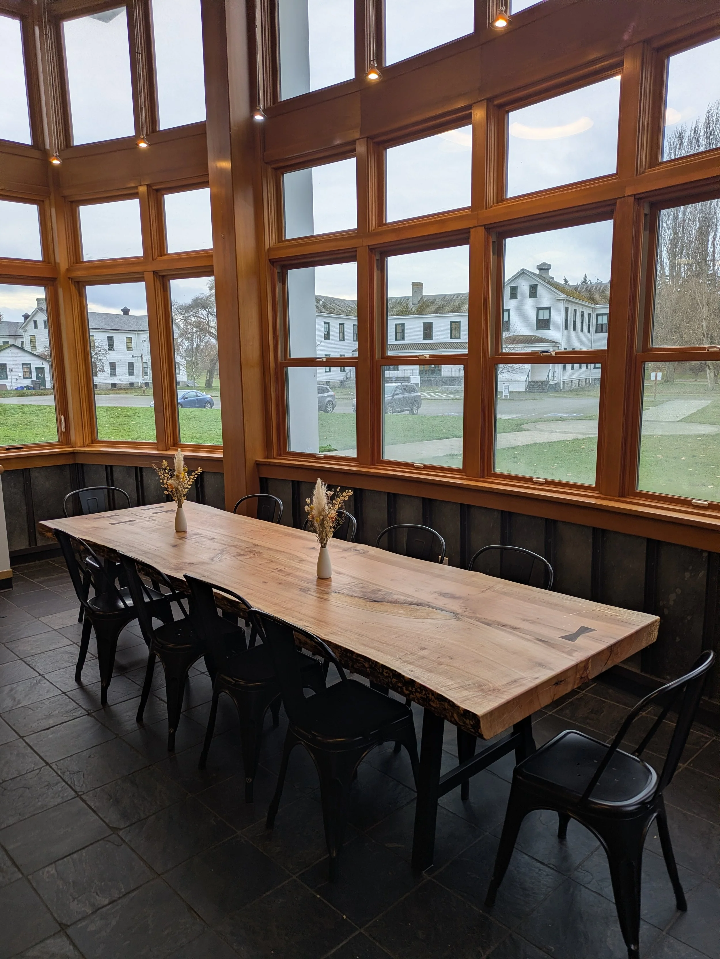 Custom slab dining table in big leaf maple, angled view showing live edge and dovetail keys