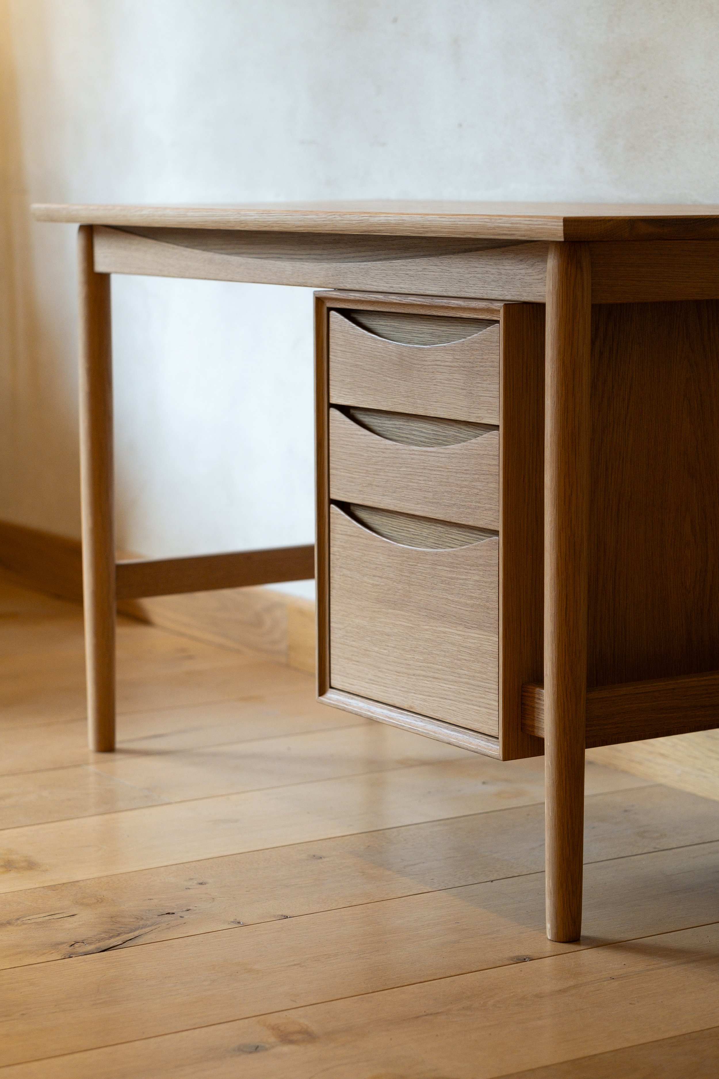 Wren Desk floating three-drawer bank detail, ammonia-fumed ellipse pulls