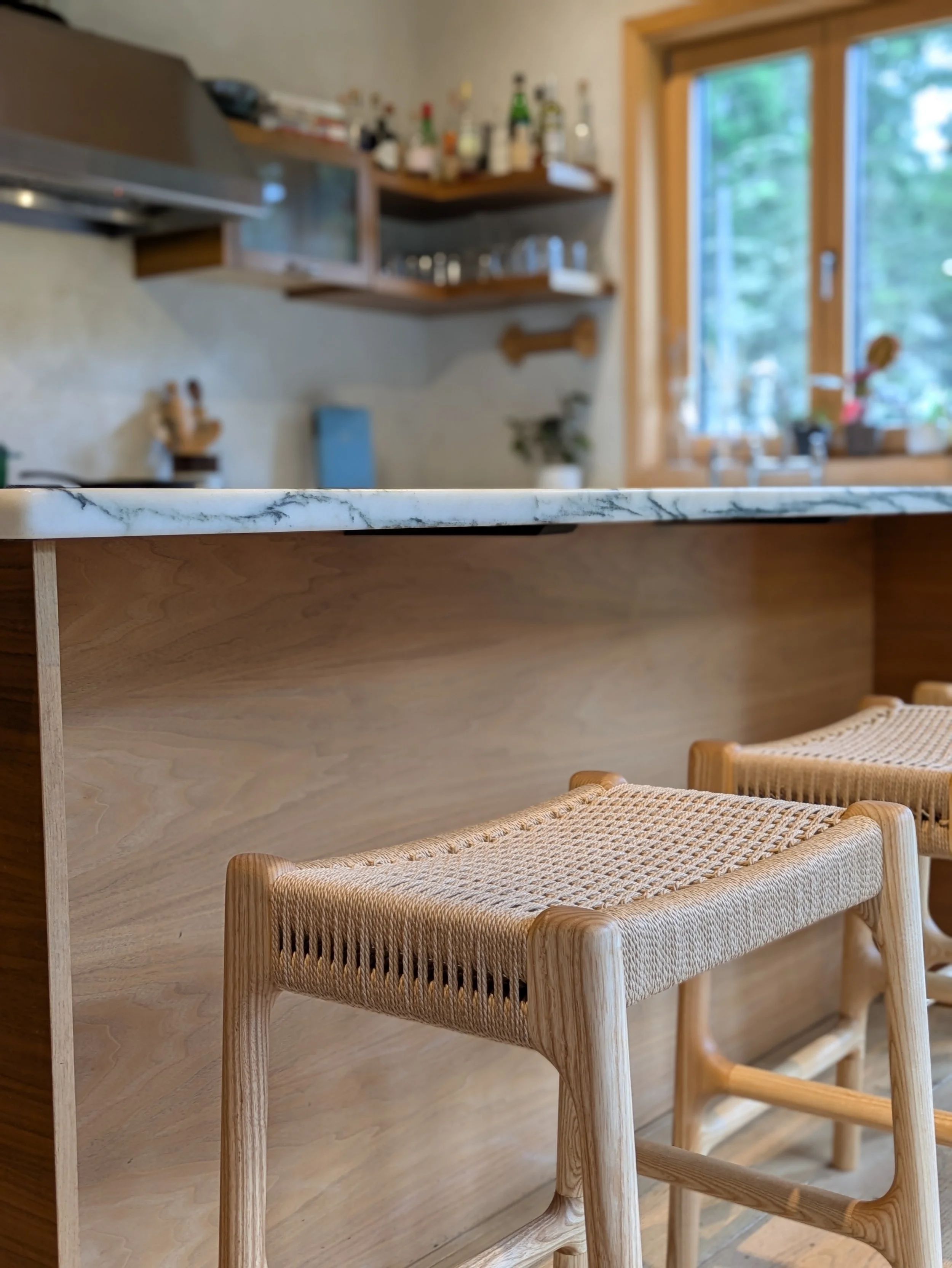 Rast counter stool at kitchen island corner, hand-woven Danish cord seat detail