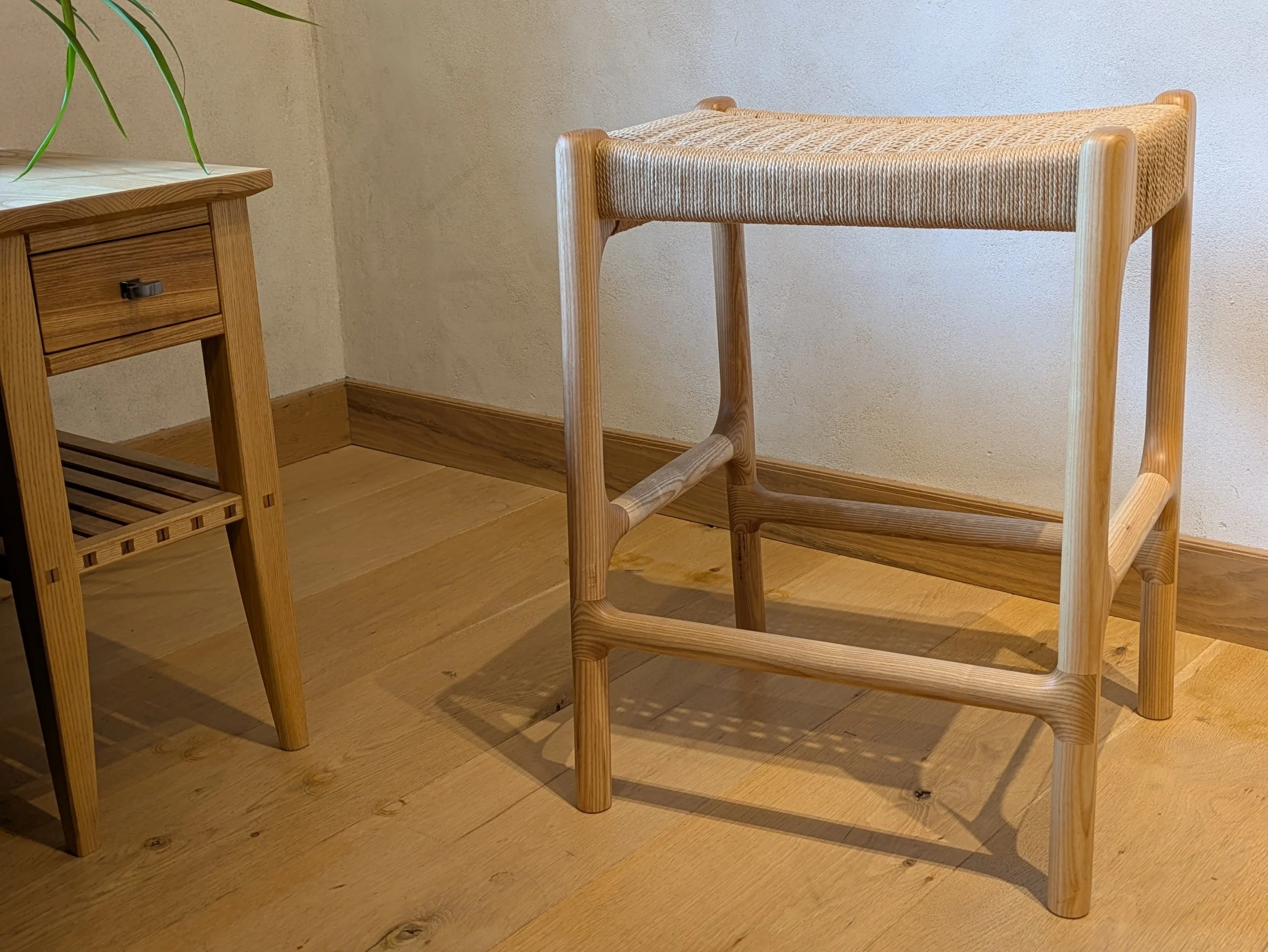 Rast counter stool side view showing curved stretcher and low side rail joinery