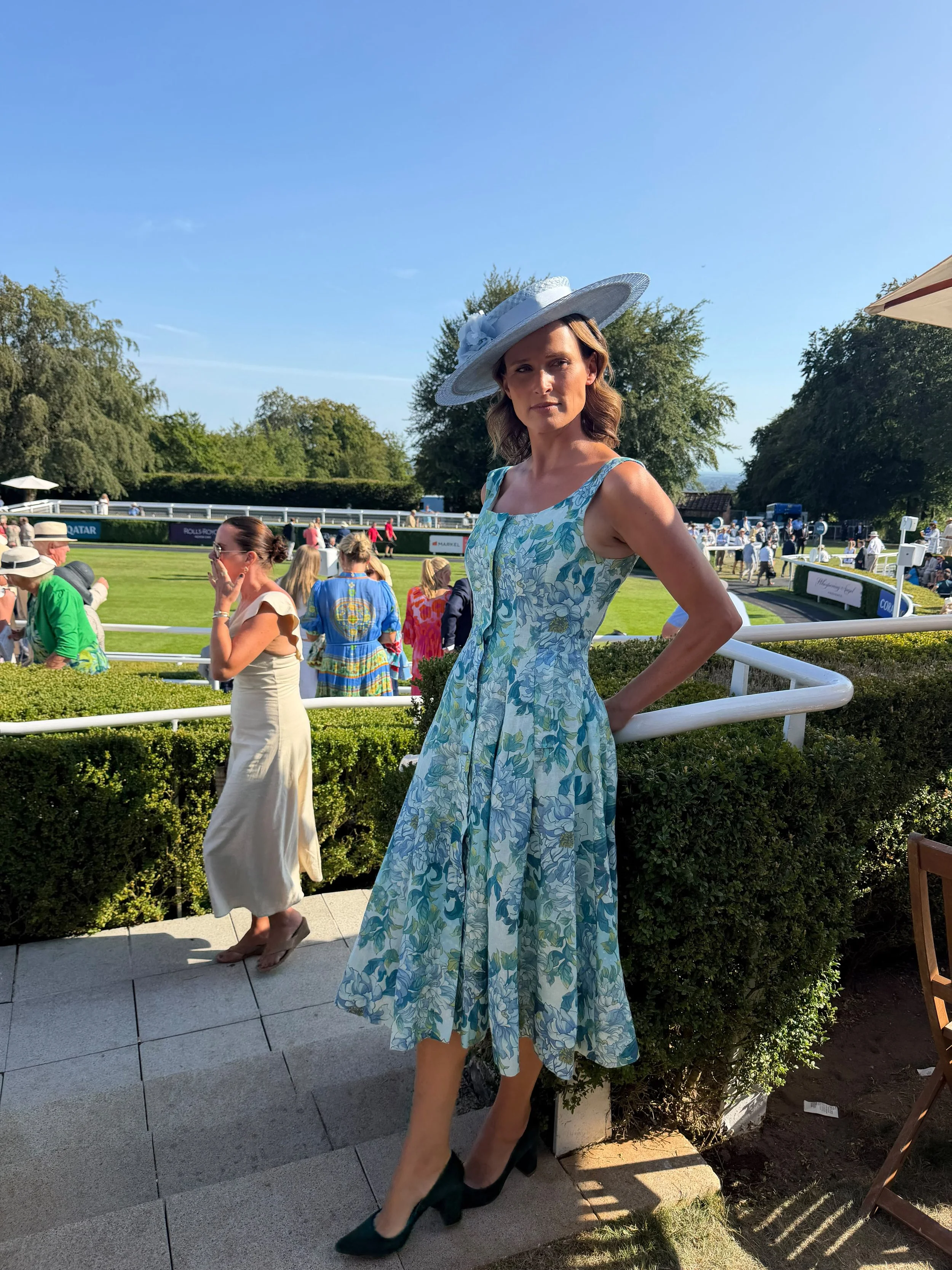 Francesca Cumani wearing a large parisisal straw and basketweave sinamay boater at Goodwood Races