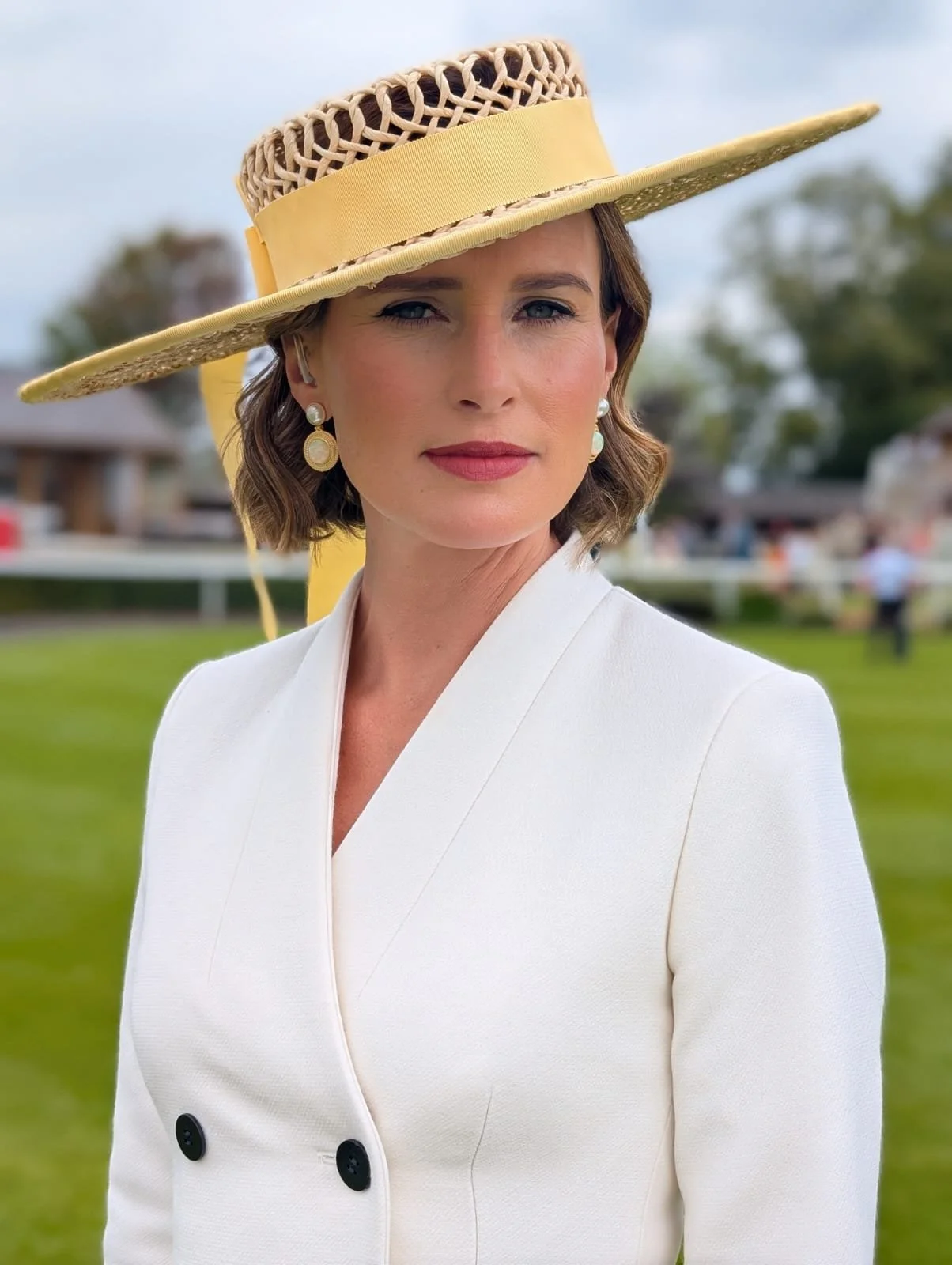 Francesca Cumani wearing a twisted raffia stra large boater at York Races