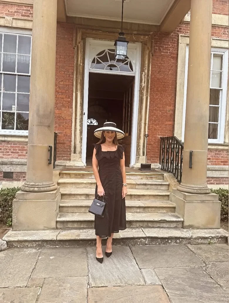 Jane Buick in a large sisal straw 'dior' down brim hat 