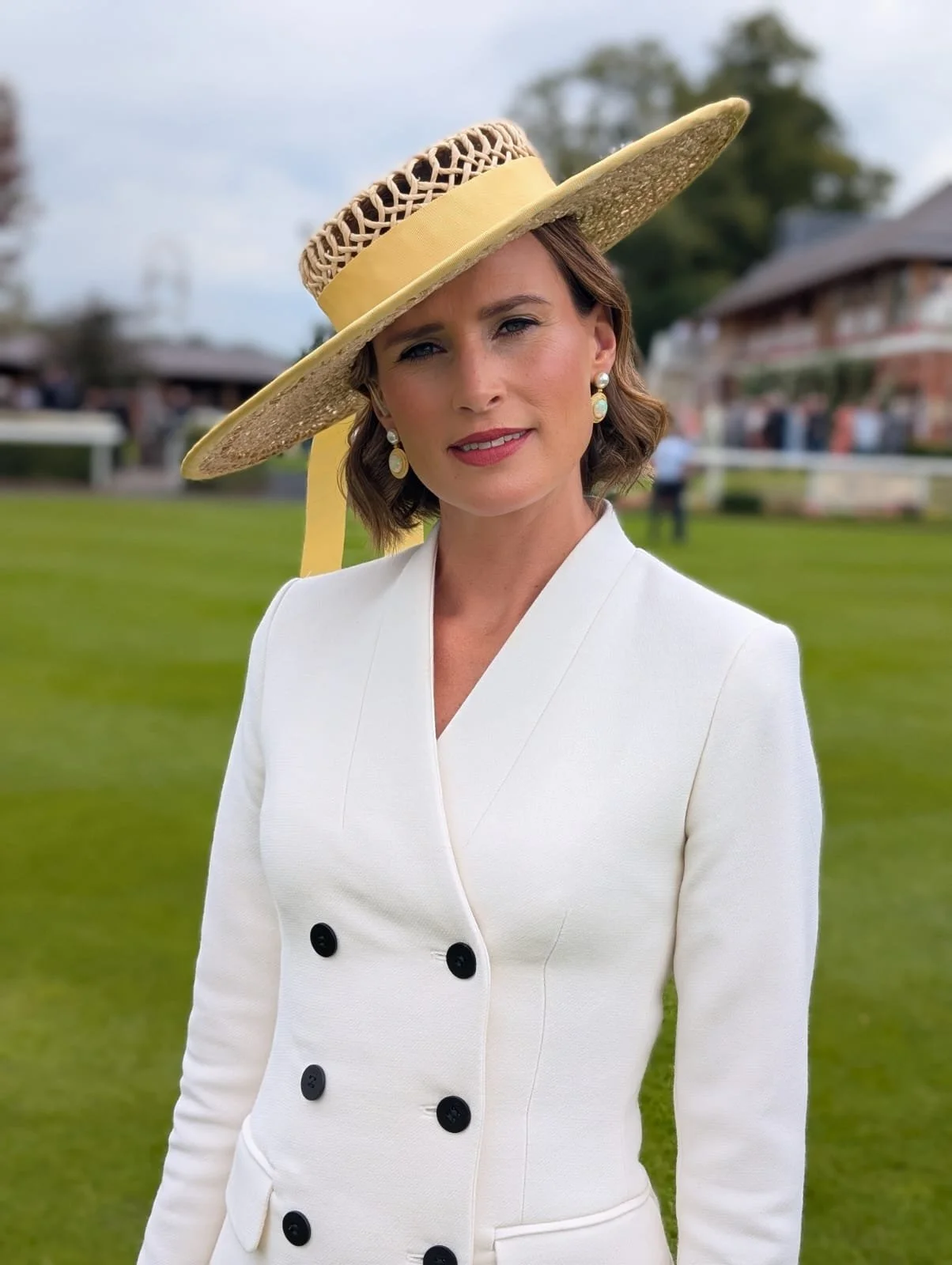 Francesca Cumani wearing a twisted raffia large boater at York Races