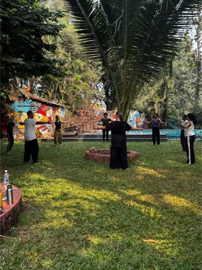 Group practicing mindful movement and outdoor meditation at The Art Farm, Goa - wellness and nature retreat in India