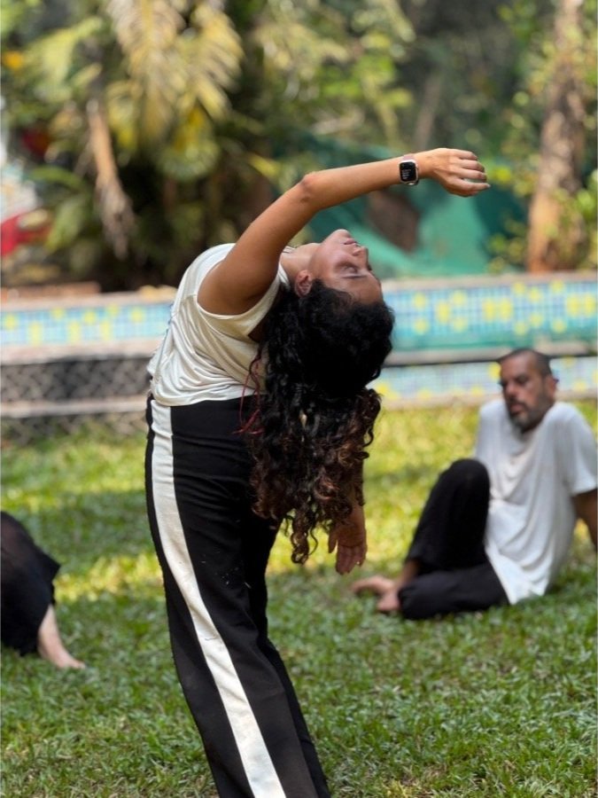 Participant practicing expressive body movement during an outdoor workshop at The Art Farm, Goa - mindful dance and movement retreat in India.