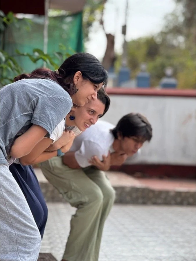 Participants sharing a playful group exercise during a movement workshop at The Art Farm, Goa - creative body expression and community learning in India