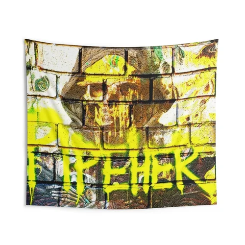 Graffiti art on a brick wall, featuring a human face and yellow spray-painted words.