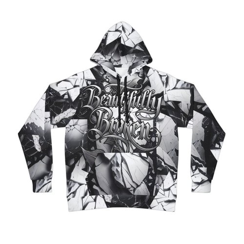 Black and white hoodie with a shattered mirror pattern and the words 'Beautifully Broken' written in stylized script on the front.
