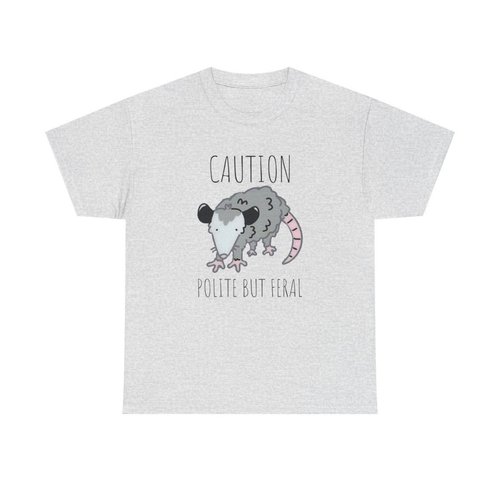 Gray T-shirt with a cartoon feral rat illustration, featuring a long pink tail, and the text 'Caution Polite but Feral'.