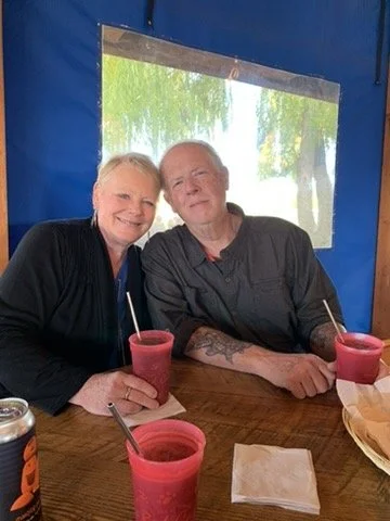 Jackie and Mark Armstrong smiling together at a table.