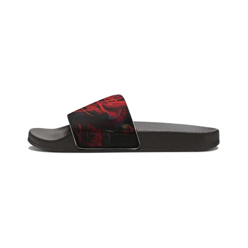 A black slide sandal with a wide strap featuring a red and black design.