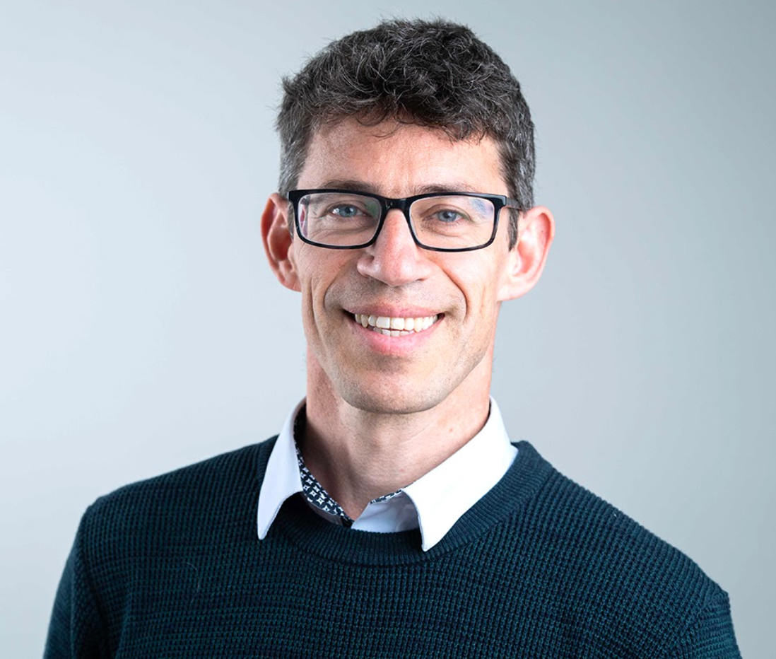 Frank Venmans Headshot of a man with dark hair, glasses, wearing a suit