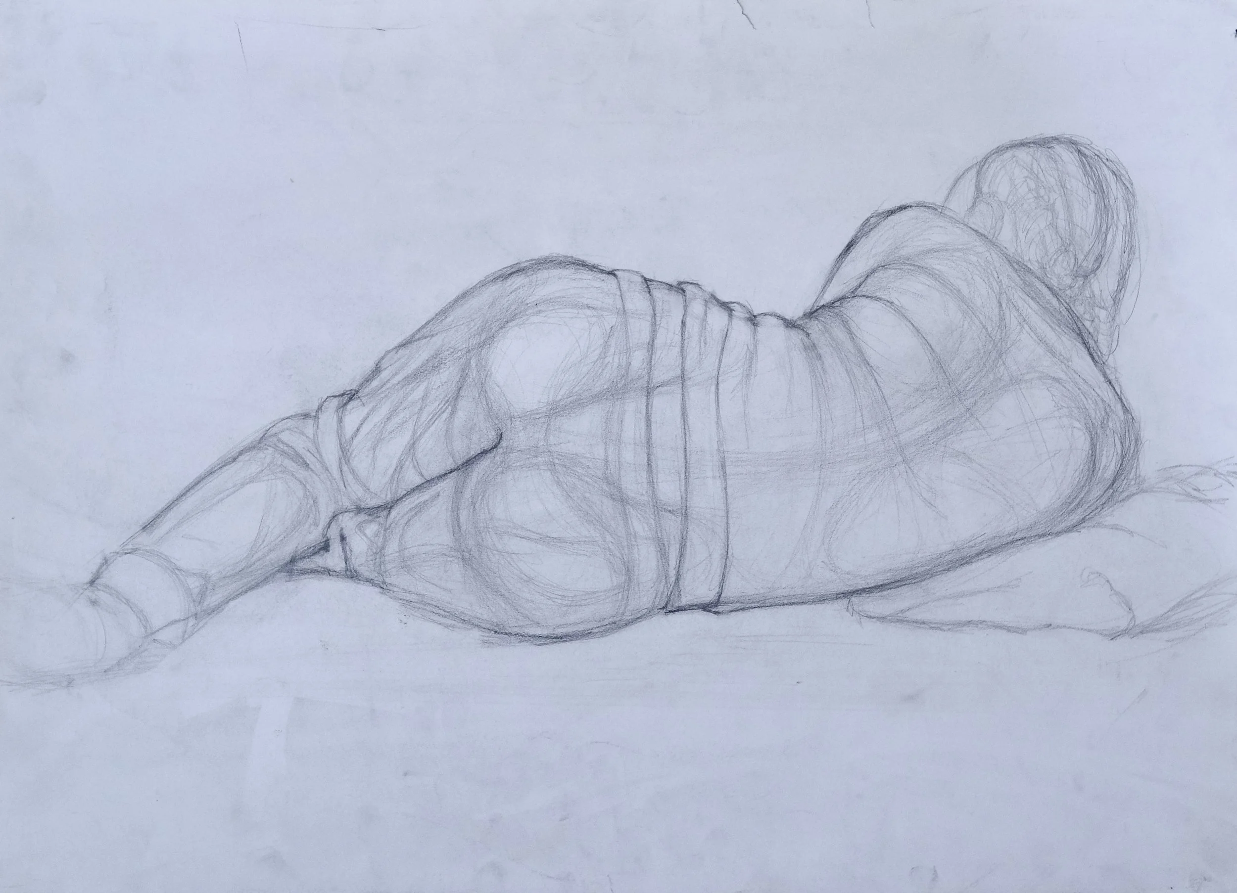 Pencil sketch of a person lying on their side, facing away, with legs bent and arms positioned near the head.