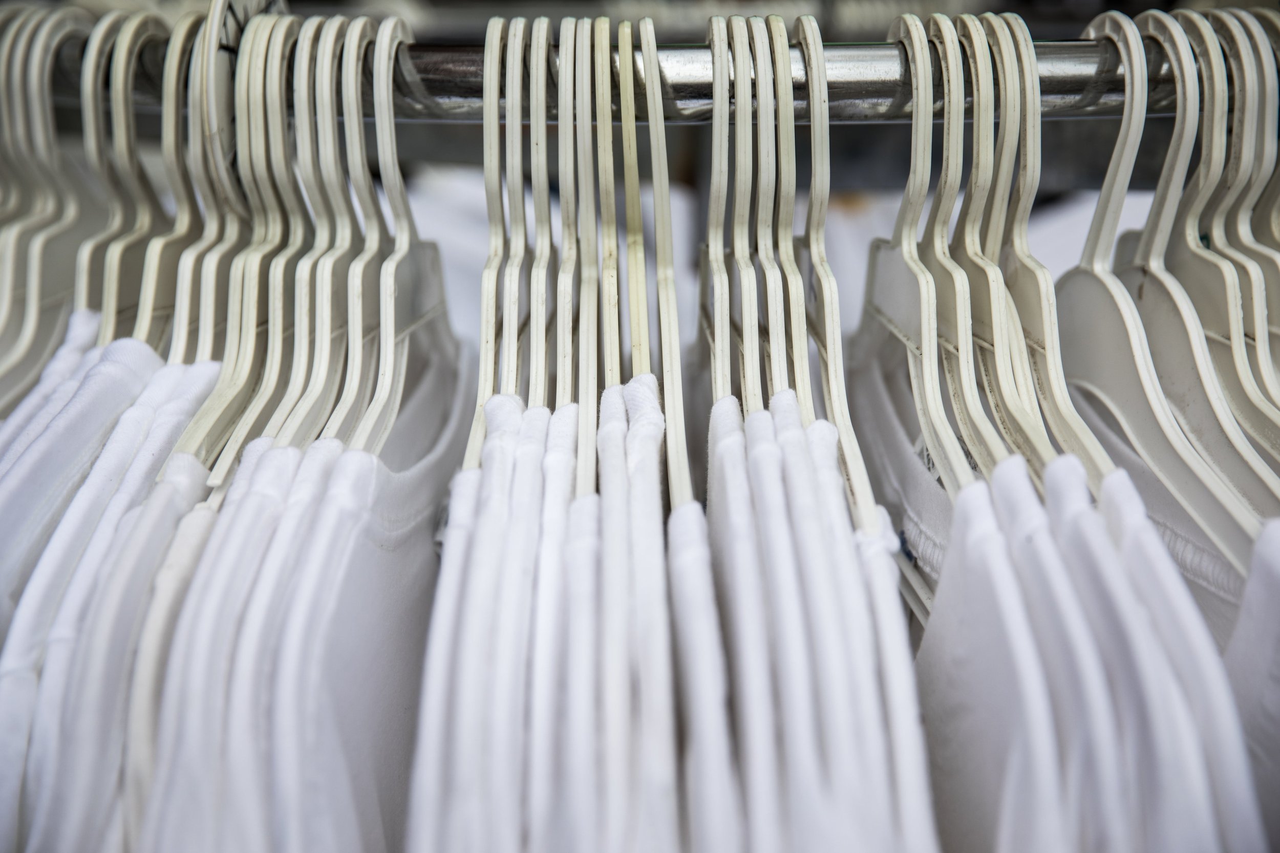 white-cotton-t-shirts-on-store-rack.jpg