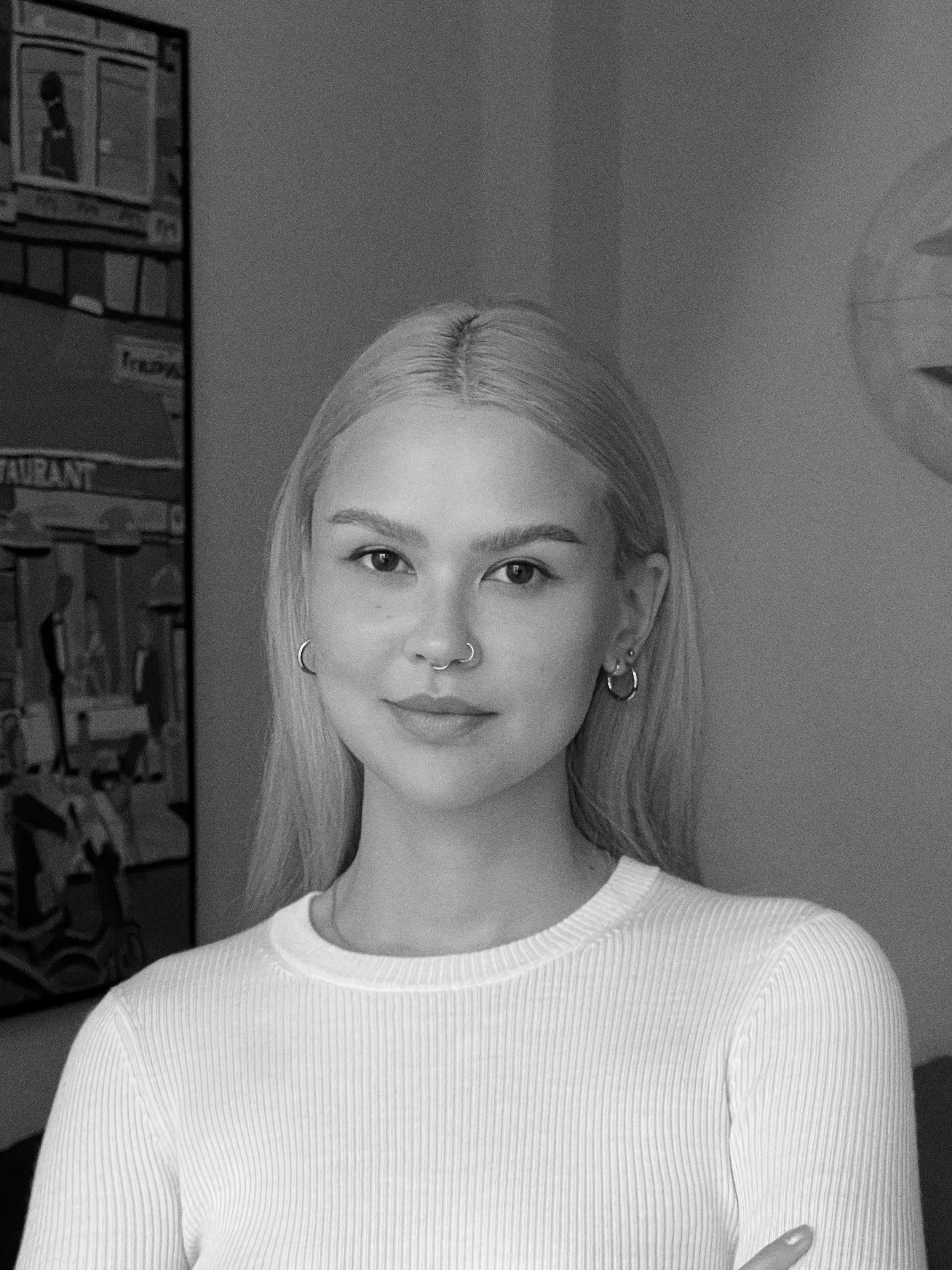 Portrait of Marilyn Djie, talent advisor, in a minimalist indoor setting