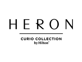 HERON hotel logo with the words "CURIO COLLECTION BY HILTON" underneath