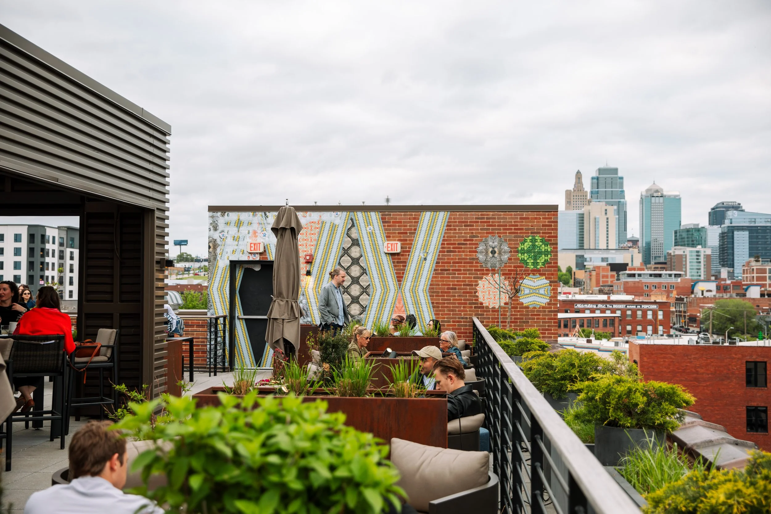 Guests sitting outside on the rooftop at Crossroads Hotel