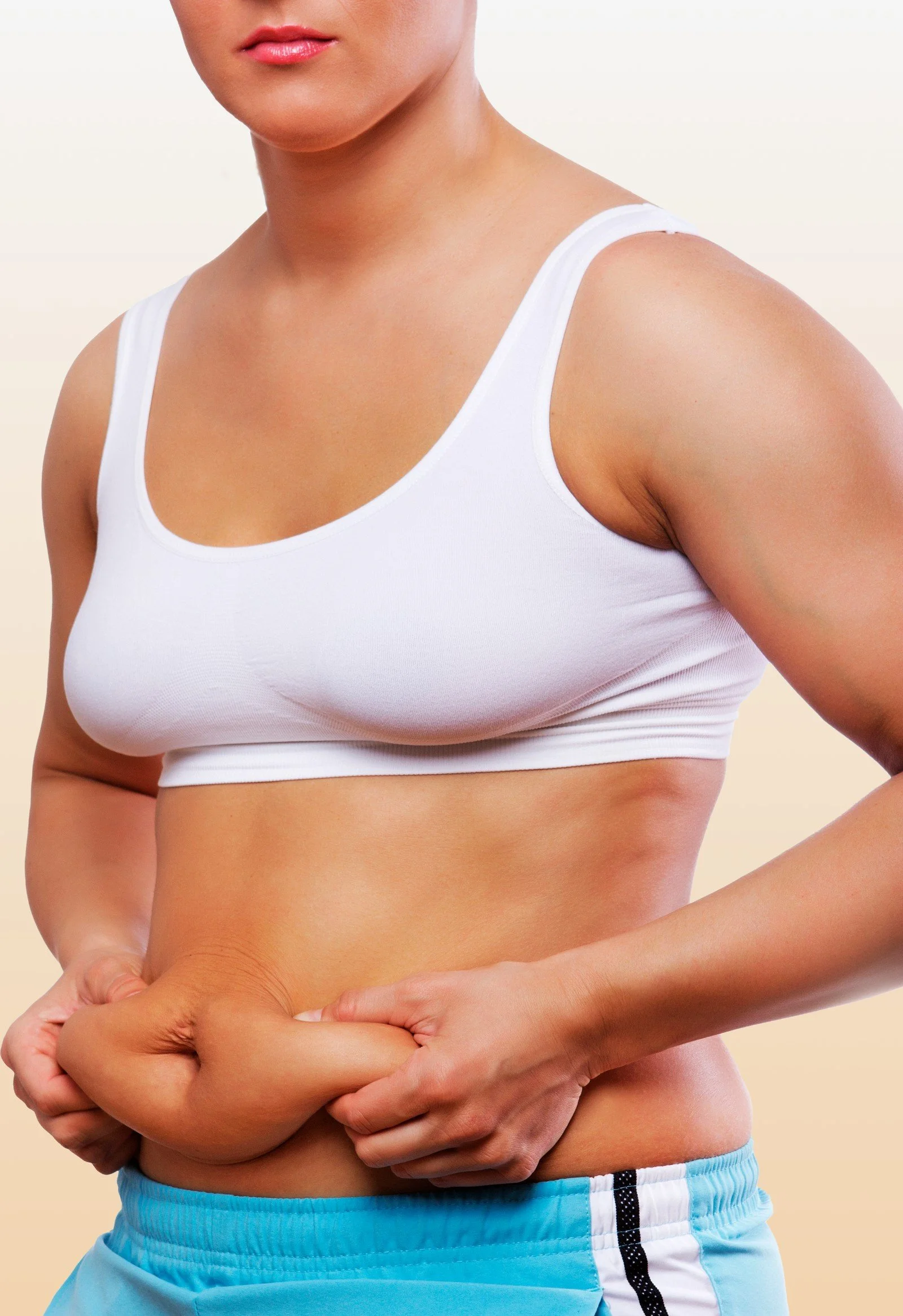Woman pinching stubborn belly fat, a good candidate for LIPOcel fat reduction in Canberra