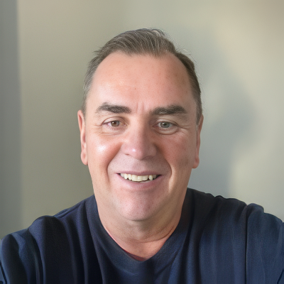 Glenn Evans. A network engineer. A smiling man with short dark hair, wearing a dark blue shirt, looking at the camera against a light background.