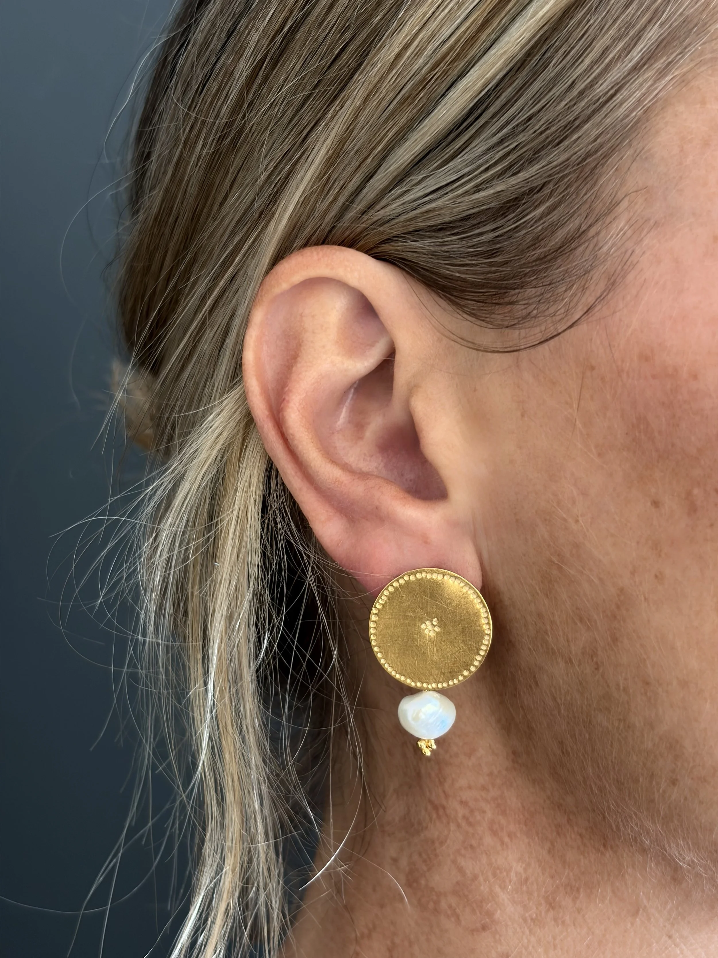 Close-up of the 2cm Pearl Belak earring worn, showing the hand-marked gold vermeil disc and small freshwater pearl.