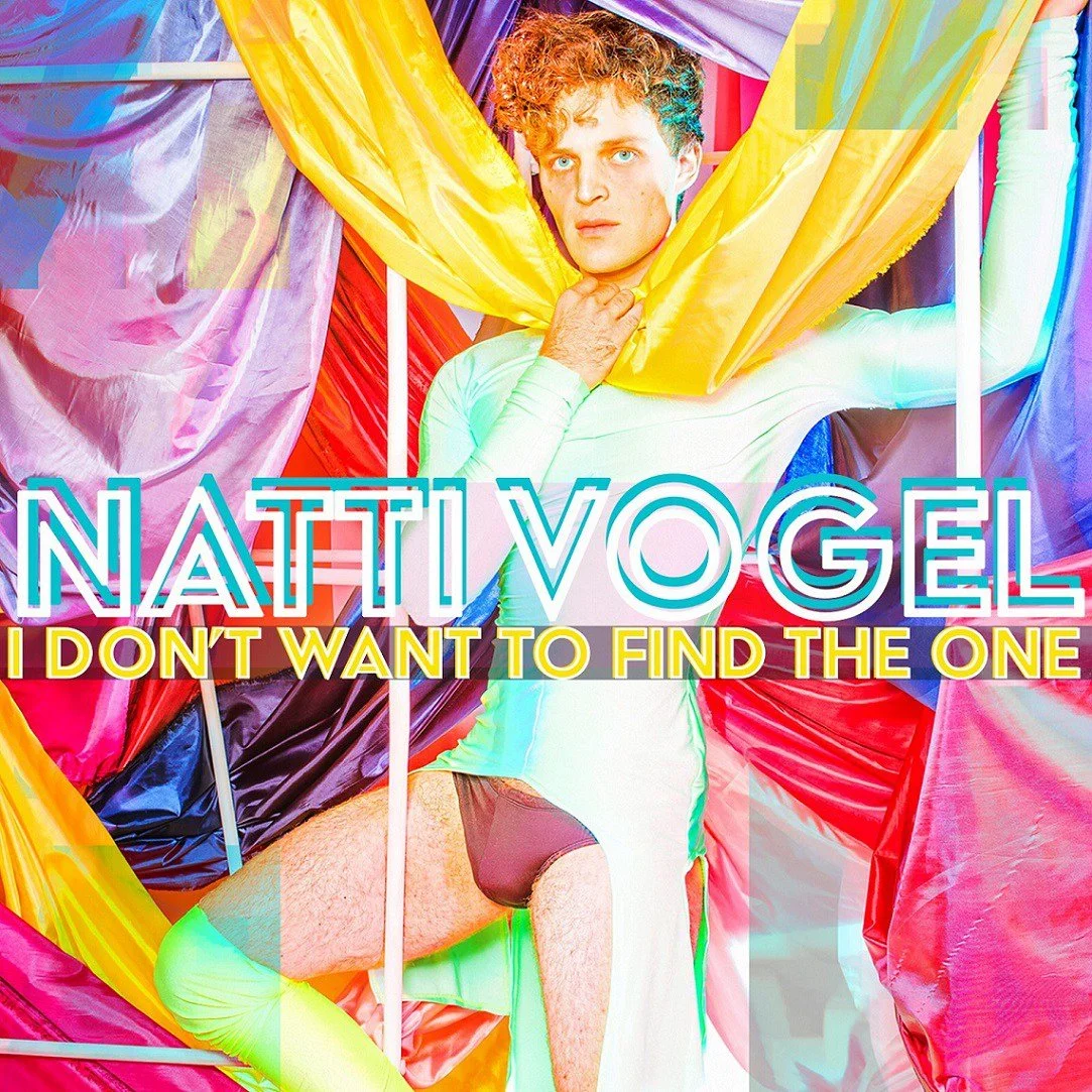 Natti Vogel wearing a shiny, pale green bodysuit. The background is filled with colorful, flowing colorful fabrics. Natti is holding a yellow fabric with one hand. Text over the image reads "NATTI VOGEL" and "I DON'T WANT TO FIND THE ONE"
