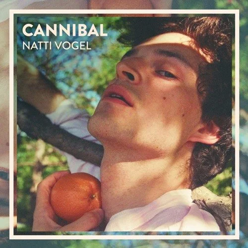 An album cover featuring a young Natti Vogel with dark curly hair holding an apple, with greenery in the background. The text reads 'CANNIBAL' and 'NATTI VOGEL'.