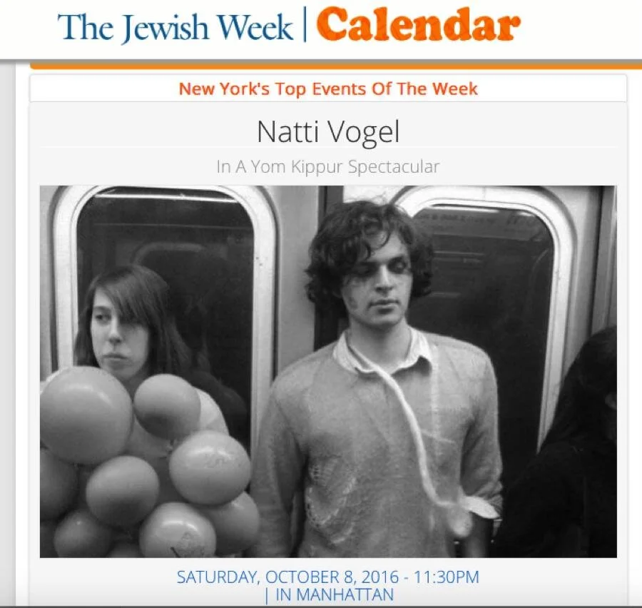 Black and white photo of a young woman and man standing next to each other inside a subway train. The woman looks serious and is holding several balloons with a girl in the background. The man has curly hair and wears a sweater with a collared shirt 
