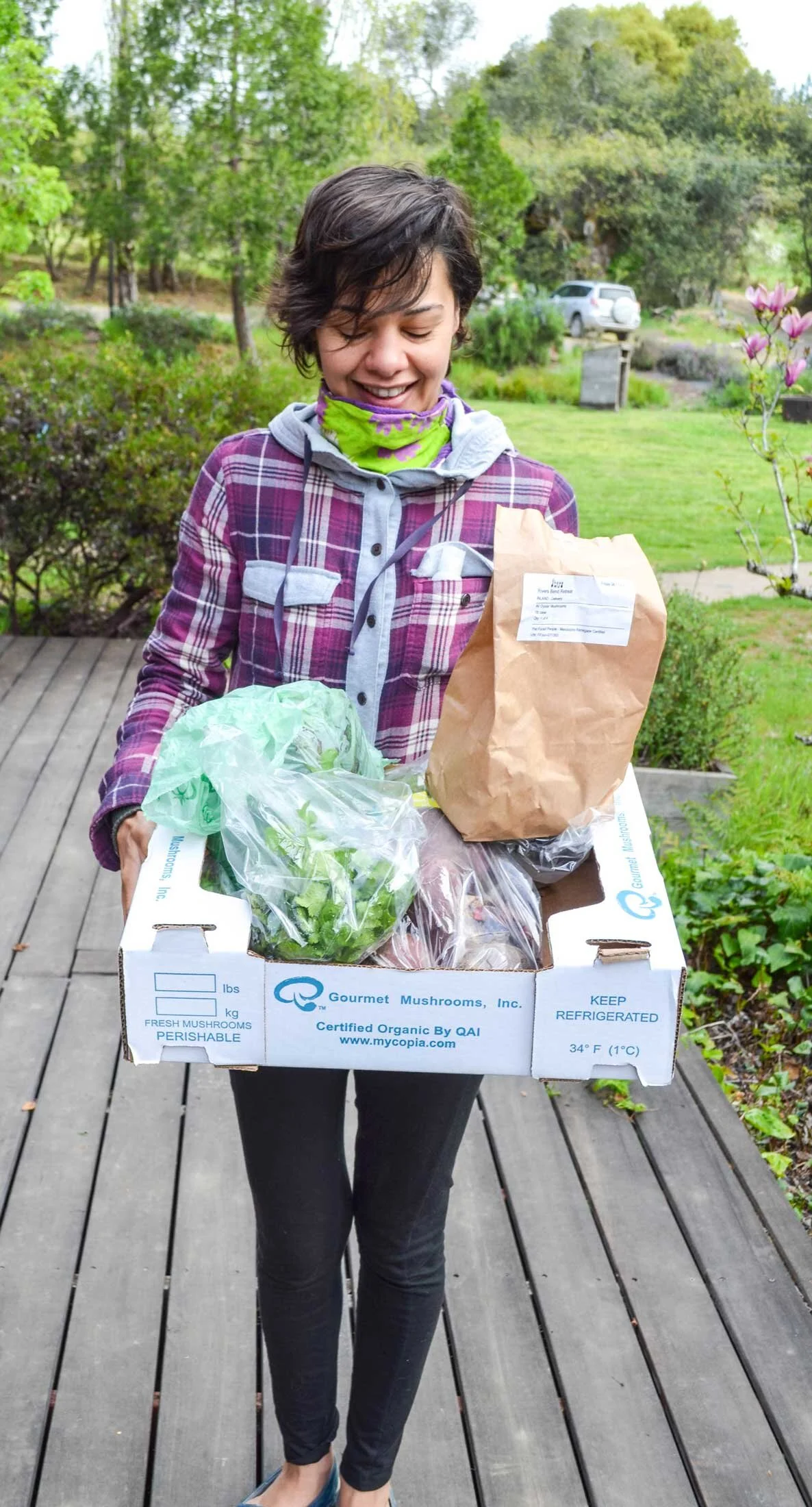 A happy buyer's club member with her order